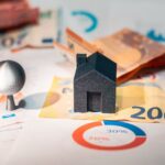 Home Conceptual image of real estate and finance involving euro currency and data charts, symbolizing investment.